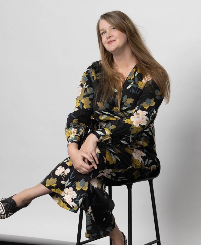 Smiling woman sitting on stool