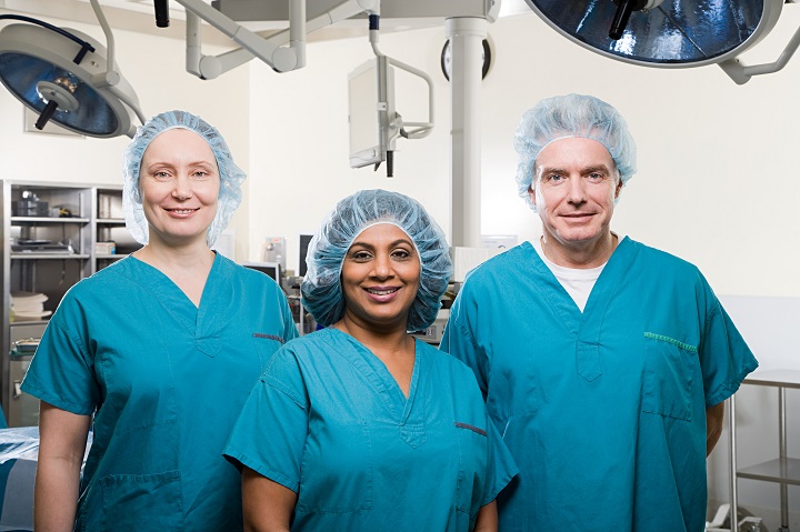 Three people in surgical scrubs